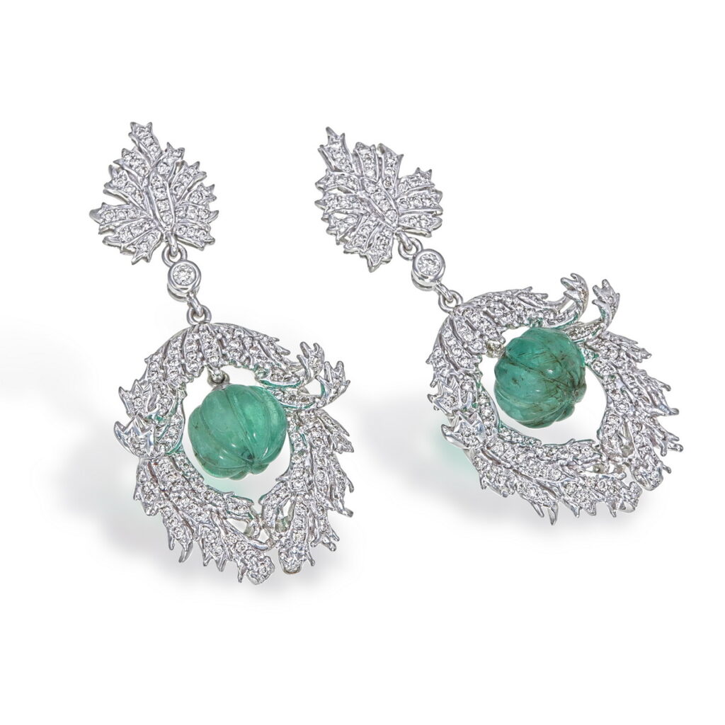 Pair of white gold Timeless Emerald Bloom Earrings with carved green emerald drops and diamond-encrusted scroll motifs.